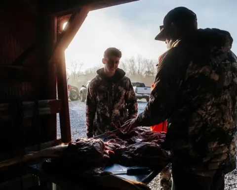 two men in a skinning shack after a hunt