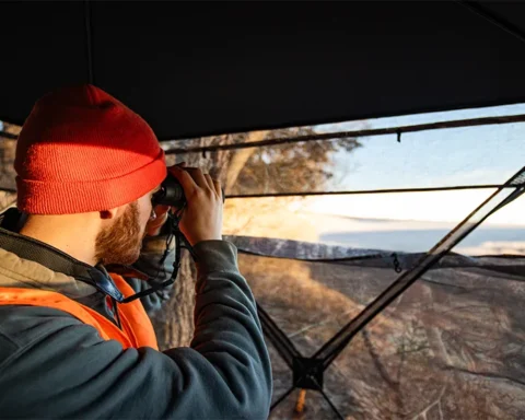 man glassing from a deer blind