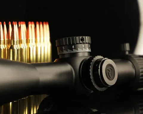 Close up view of a scope next to ammunition