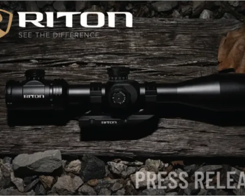 Riton press release graphic with a scope on a wood board near rocks