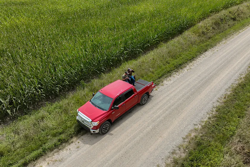 scouting a deer hunting spot from a truck bed