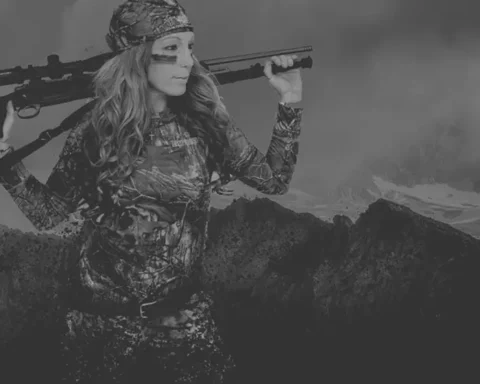 girl holding a gun over her shoulders in camo clothing